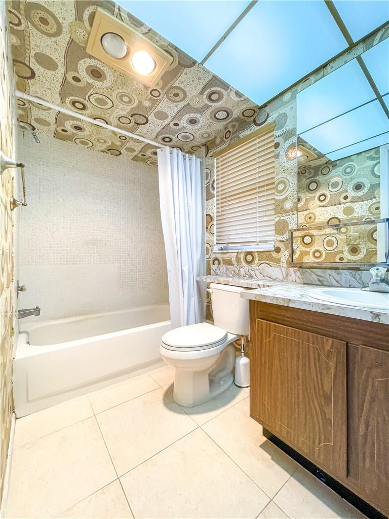 2781 North Pine Island Road, Unit 308 Sunrise, FL 33322 - Photo 16 of 16 a bathroom with a bathtub sink mirror vanity and toilet