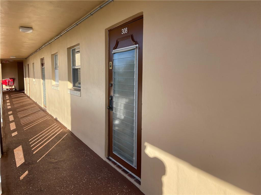 2781 North Pine Island Road, Unit 308 Sunrise, FL 33322 - Photo 4 of 16 a view of a hallway with wooden floor and staircase
