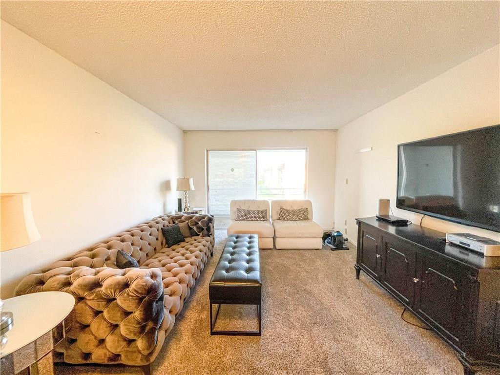 2781 North Pine Island Road, Unit 308 Sunrise, FL 33322 - Photo 10 of 16 a living room with furniture and a flat screen tv