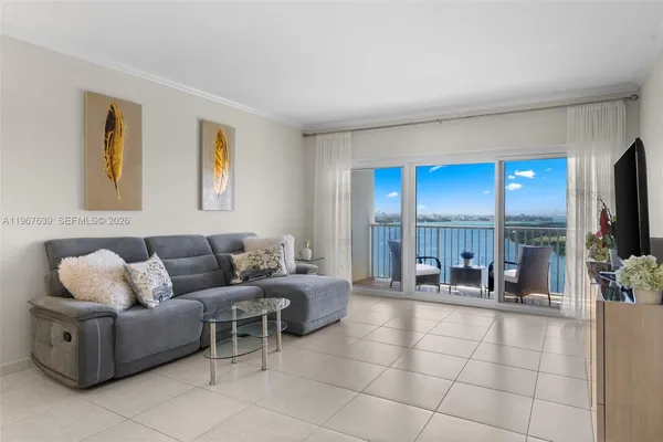 a living room with furniture and a floor to ceiling window