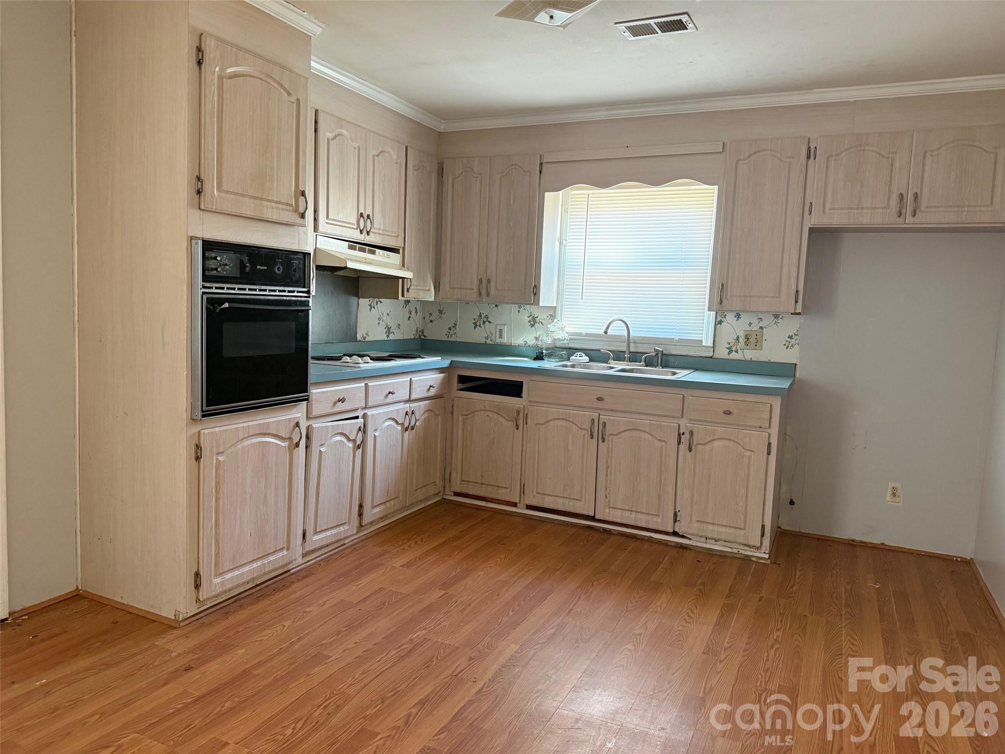 427 Clinton Avenue Lancaster, SC 29720 - Photo 2 of 7 a kitchen with stainless steel appliances granite countertop a stove a sink and white cabinets