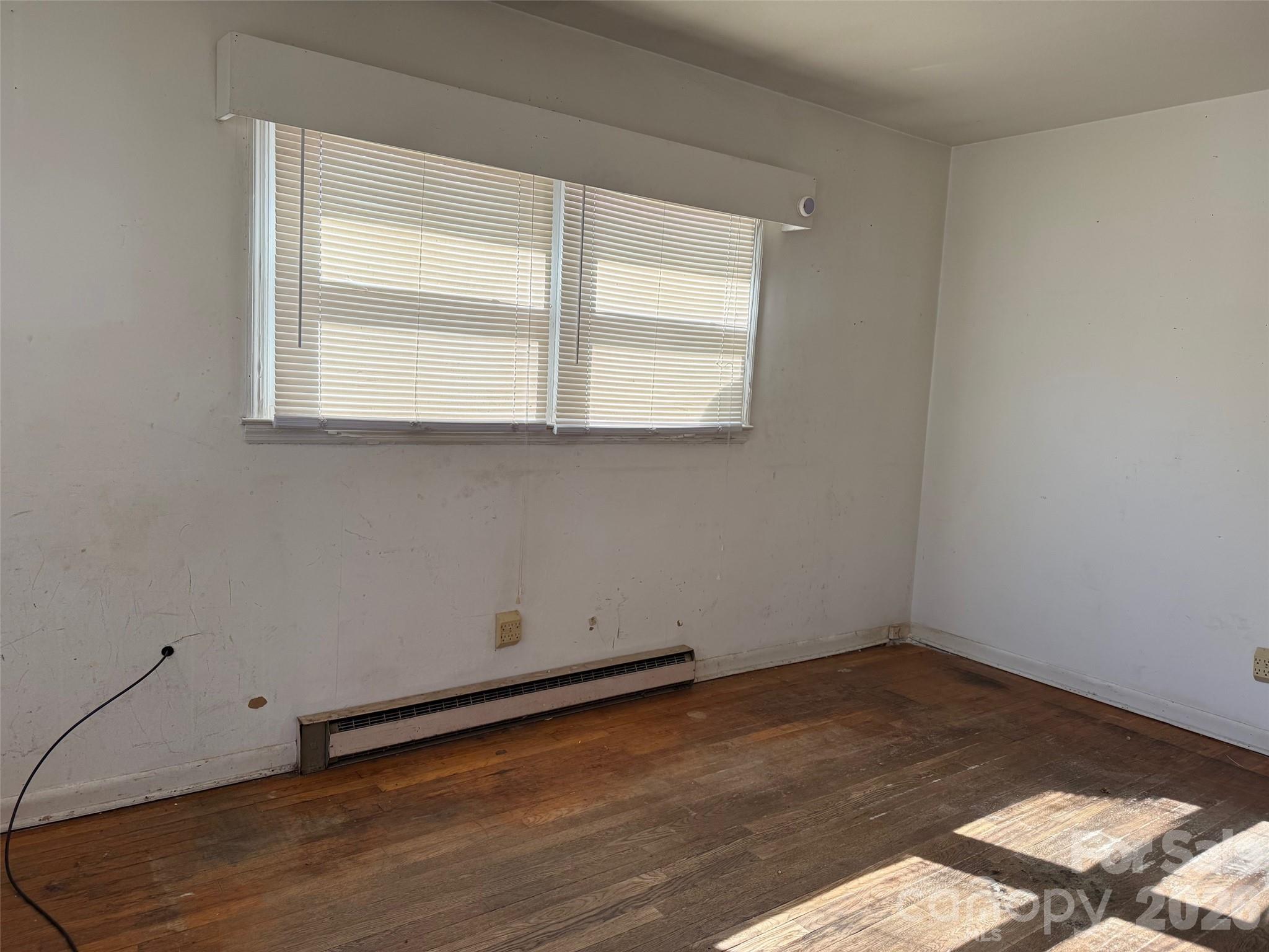 427 Clinton Avenue Lancaster, SC 29720 - Photo 4 of 7 a room view with wooden floor and windows