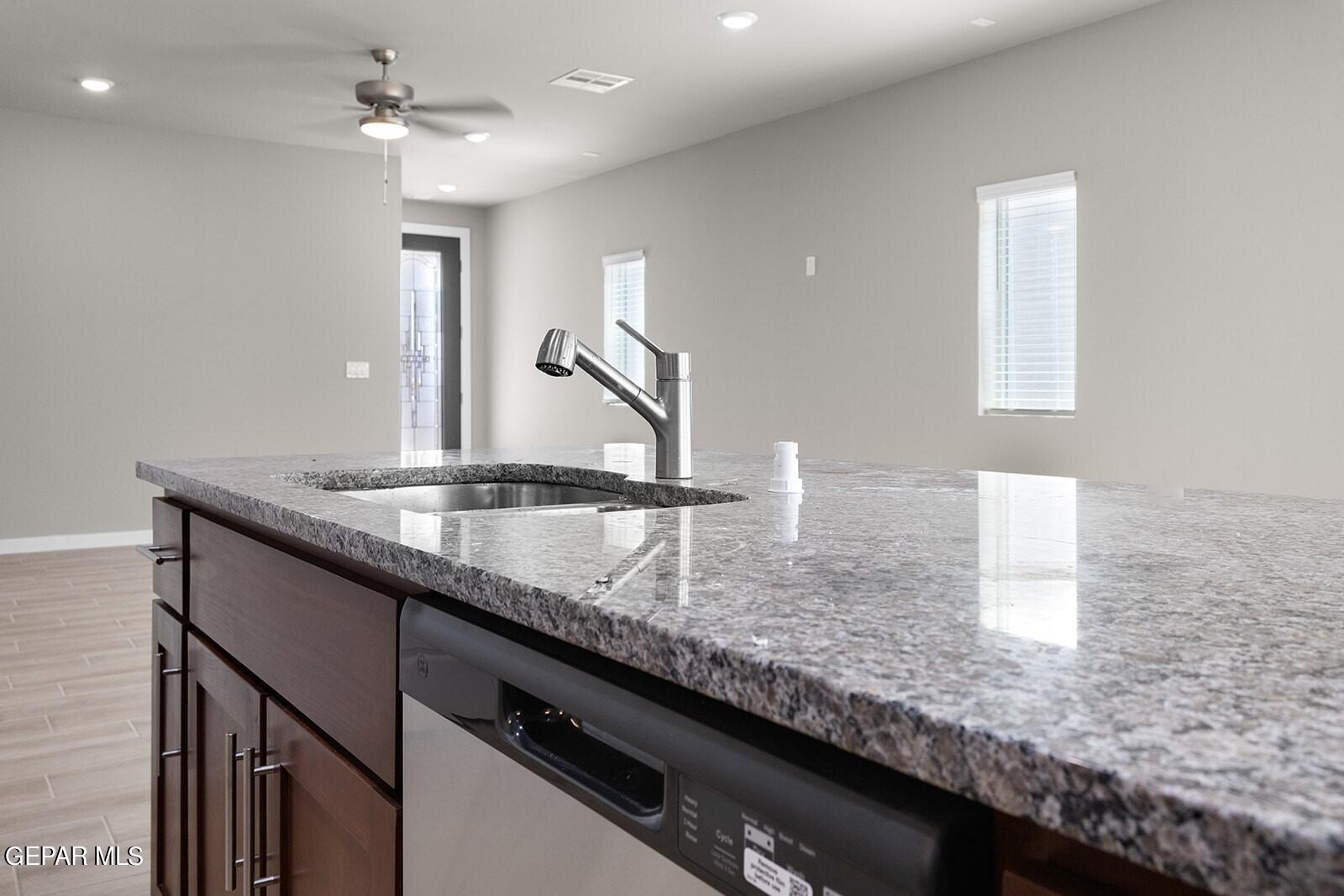 15228 Destination Avenue El Paso, TX 79938 - Photo 12 of 29 a kitchen with granite countertop a sink and a counter top space