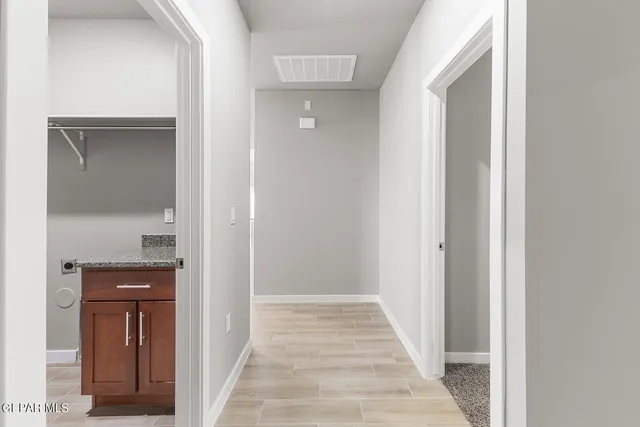 an empty room with closet and a window