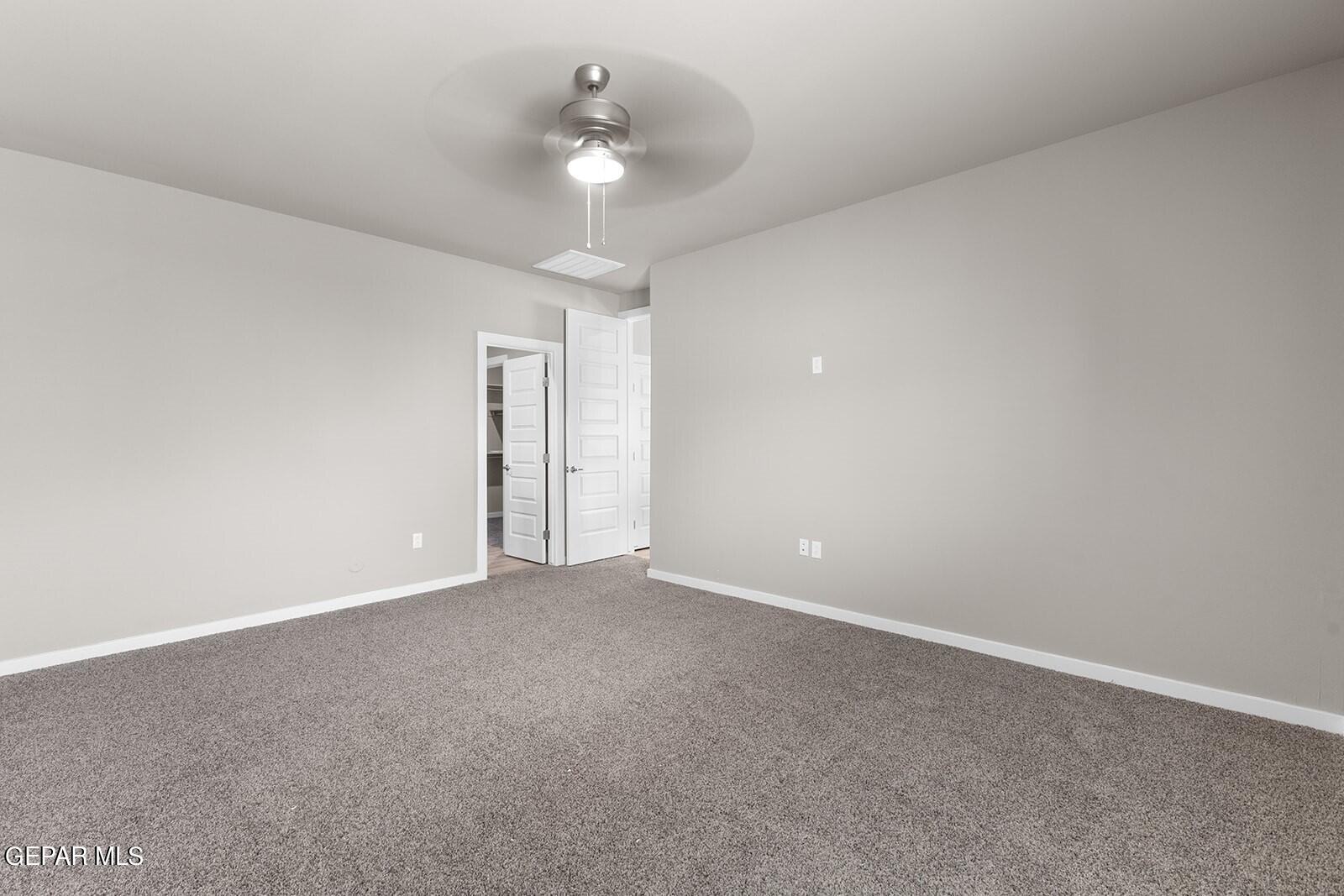 15228 Destination Avenue El Paso, TX 79938 - Photo 22 of 29 a view of an empty room with a chandelier fan