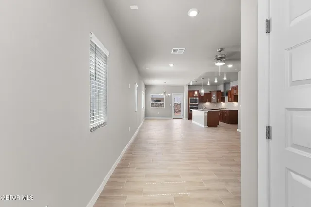 a view of a kitchen with a refrigerator and a window