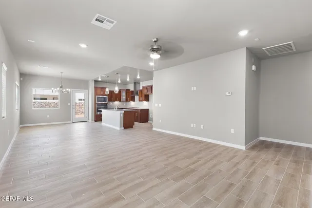 a view of a kitchen with a sink and a refrigerator