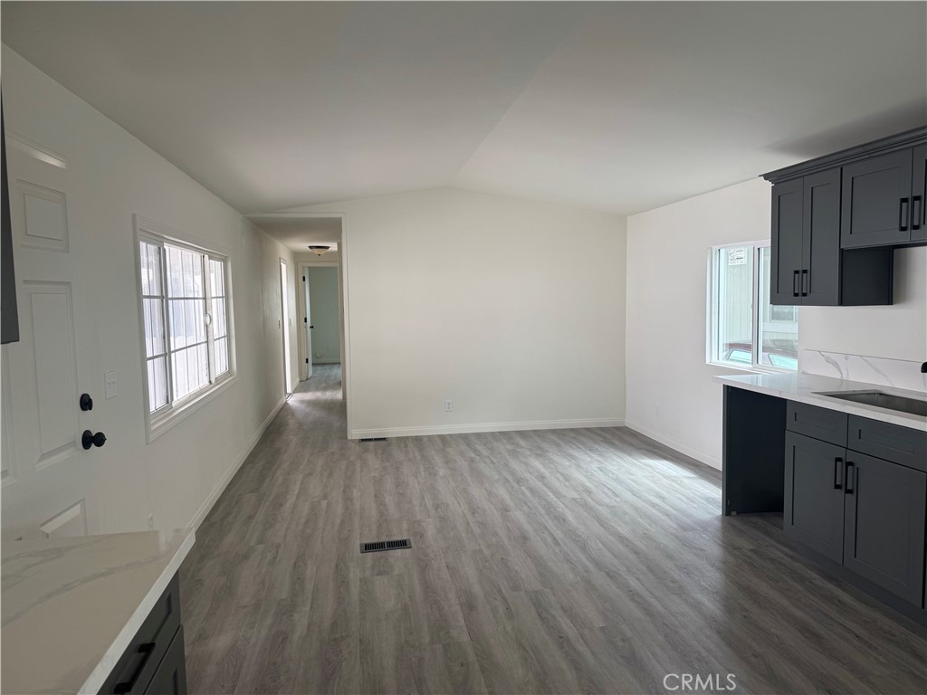 715 West 220th Street, Unit 47 Torrance, CA 90502 - Photo 4 of 15 wooden floor in an empty room with a window
