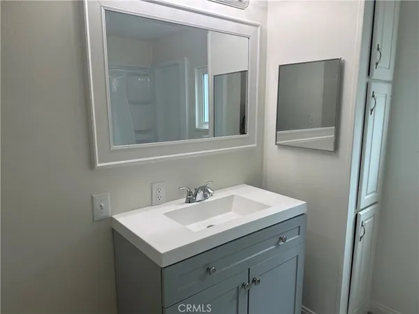 a bathroom with 2 sink and a mirror