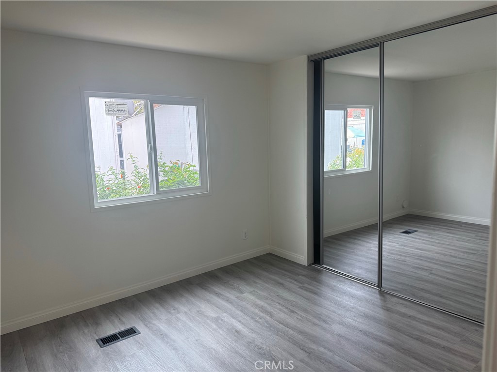 715 West 220th Street, Unit 47 Torrance, CA 90502 - Photo 9 of 15 an empty room with wooden floor and windows