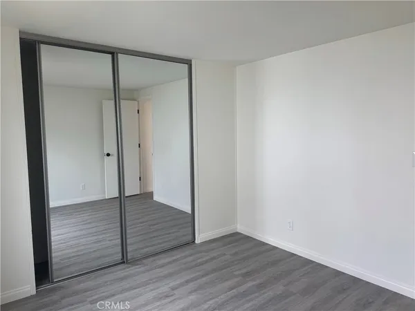 an empty room with wooden floor and wooden door