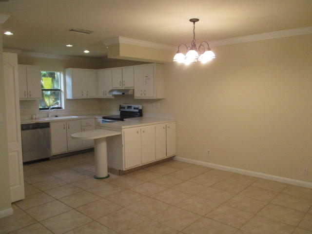 9370 Southwest 61st Way, Unit 15D Boca Raton, FL 33428 - Photo 6 of 16 a kitchen with a sink cabinets and window