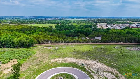 a view of a city with lush green forest