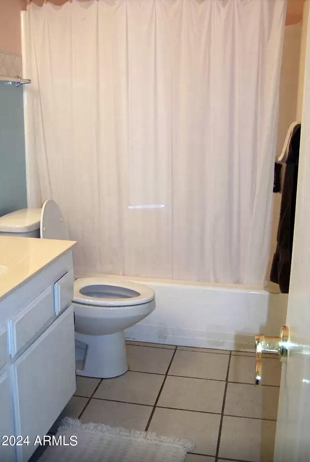 1240 Cedar Street Ajo, AZ 85321 - Photo 5 of 5 a bathroom with a toilet a sink and a mirror