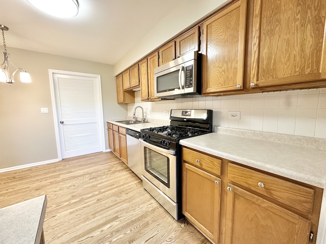 1193 Ranchview Court Buffalo Grove, IL 60089 - Photo 4 of 19 a kitchen with stainless steel appliances granite countertop a sink and a stove top oven