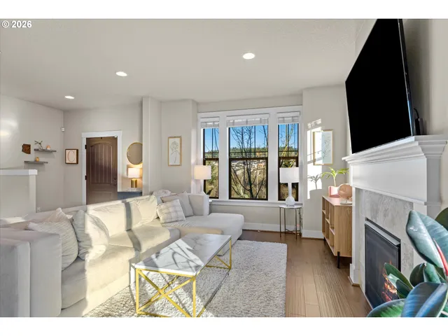 a living room with furniture a fireplace and a flat screen tv