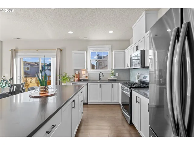 a kitchen with center island table and chairs