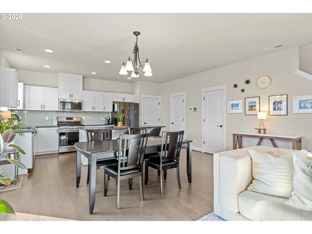 a kitchen with stainless steel appliances a stove a sink cabinets and a window