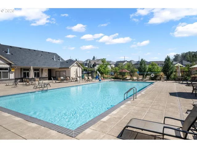 a large kitchen with a table and chairs