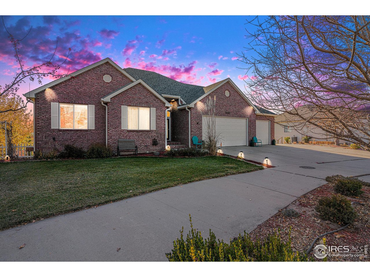 4402 30th Street Greeley, CO 80634 - Photo 2 of 31 a front view of a house with a yard and garage