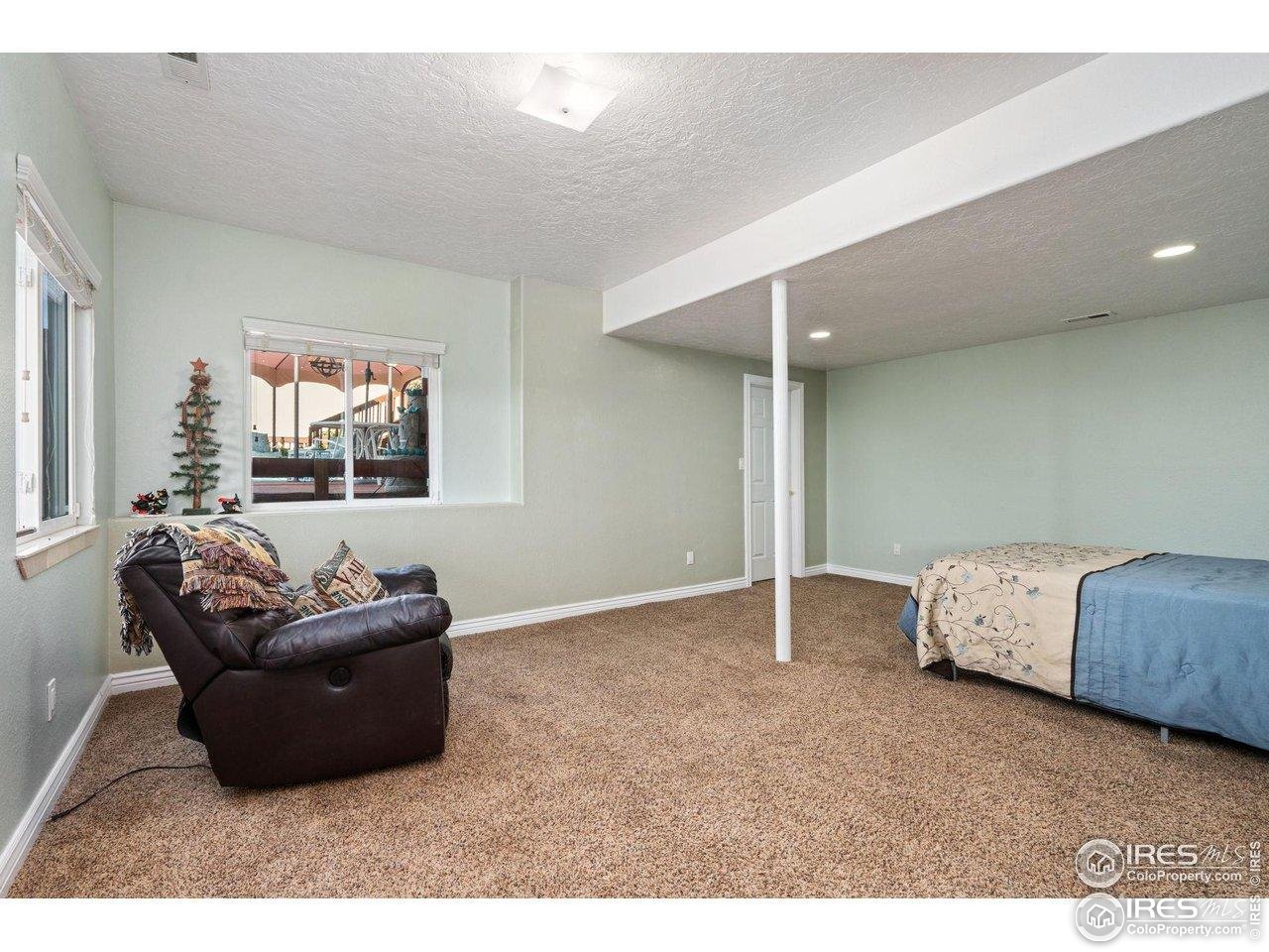 4402 30th Street Greeley, CO 80634 - Photo 21 of 31 a living room with furniture and a window