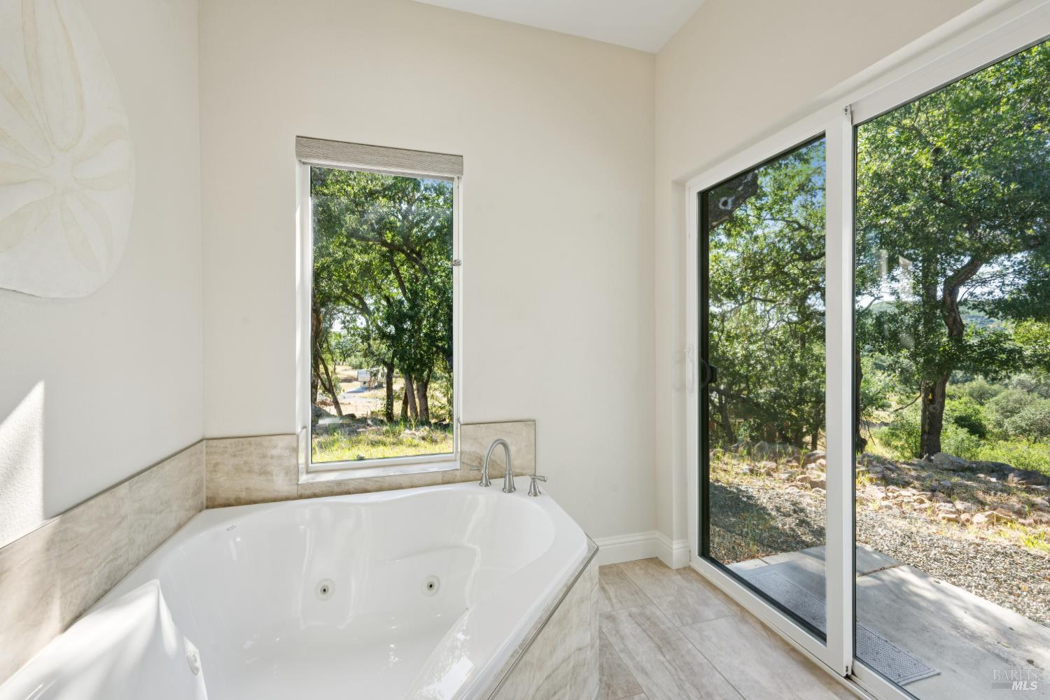 4665 Upper Ridge Road Santa Rosa, CA 95404 - Photo 34 of 71 a bathroom with a bathtub and window