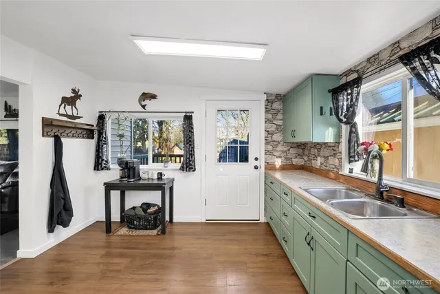 a kitchen with granite countertop a sink and a refrigerator