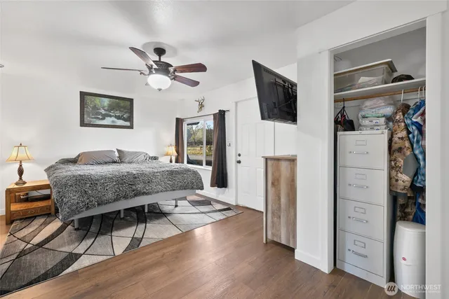 a bedroom with a bed and a flat screen tv