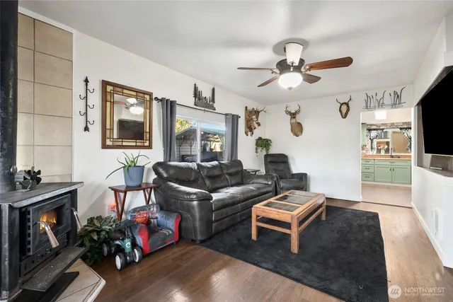 a living room with furniture a flat screen tv and a fireplace