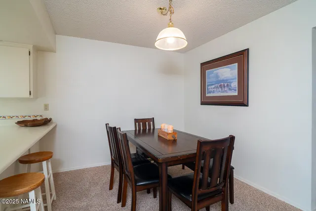 a kitchen with stainless steel appliances a microwave a stove and white cabinets