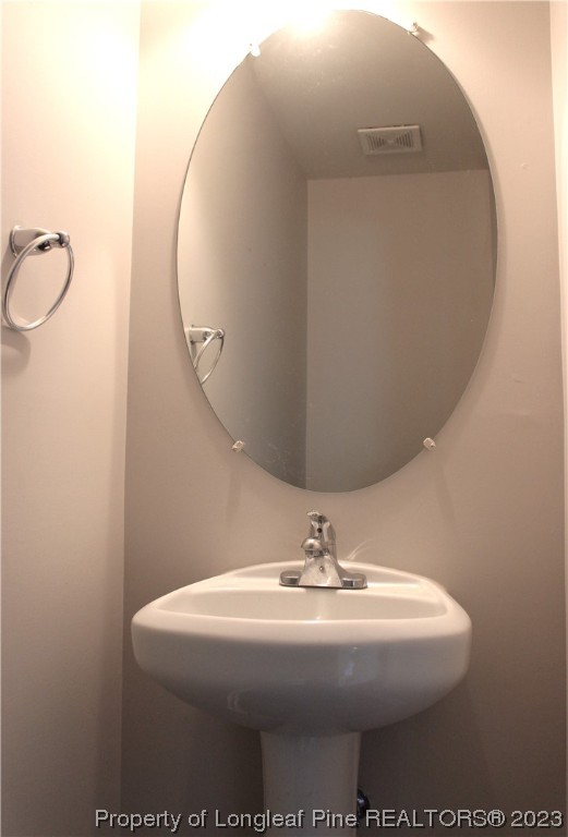 678 Cape Fear Road Raeford, NC 28376 - Photo 14 of 30 a bathroom with a sink and mirror