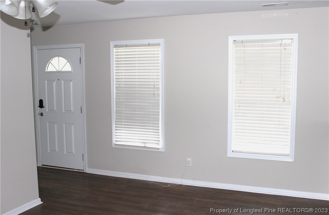 678 Cape Fear Road Raeford, NC 28376 - Photo 2 of 30 a view of an empty room with wooden floor and a window