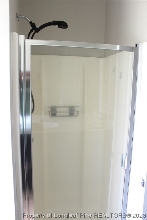 678 Cape Fear Road Raeford, NC 28376 - Photo 24 of 30 a bathroom with a glass shower door