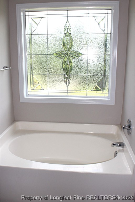 678 Cape Fear Road Raeford, NC 28376 - Photo 25 of 30 a bathroom with a bathtub and window