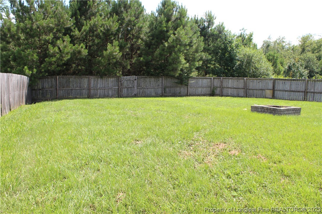 678 Cape Fear Road Raeford, NC 28376 - Photo 30 of 30 a view of a backyard with swimming pool and wooden fence