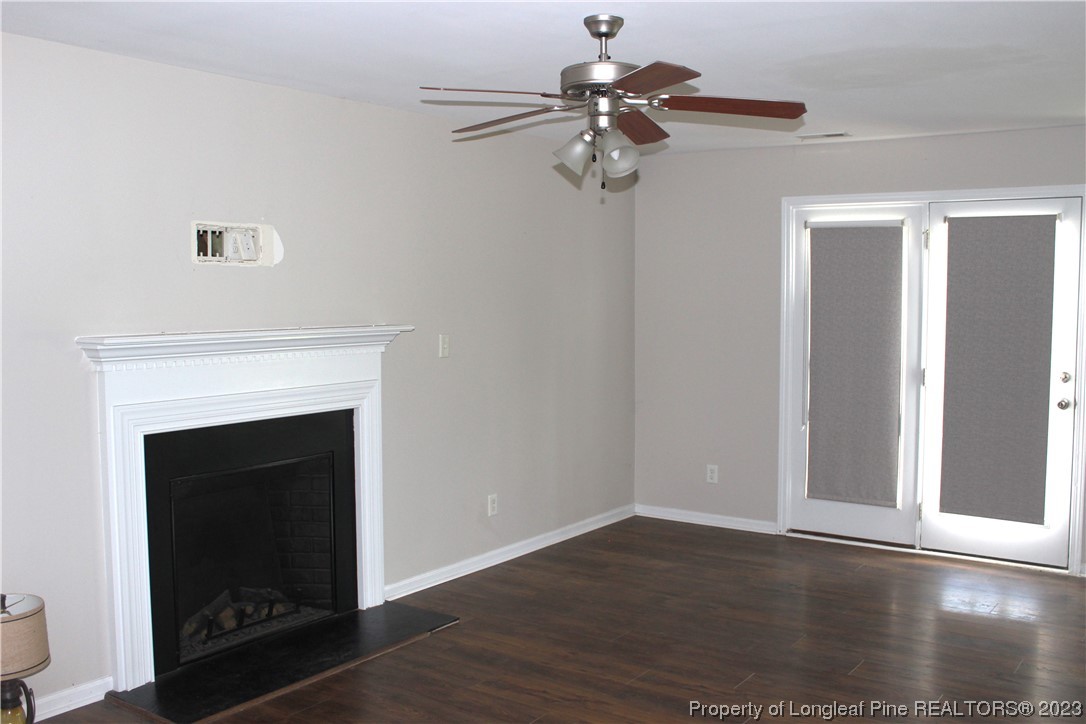 678 Cape Fear Road Raeford, NC 28376 - Photo 4 of 30 a view of a livingroom with a fireplace and wooden floor