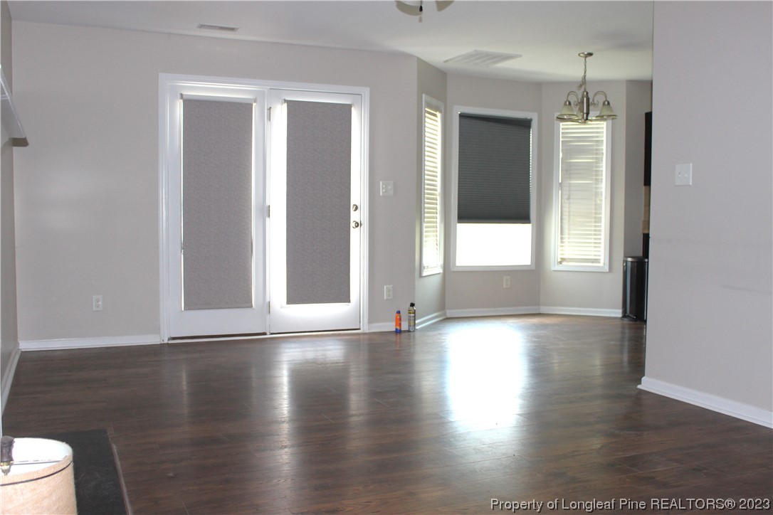 678 Cape Fear Road Raeford, NC 28376 - Photo 5 of 30 a view of an empty room with wooden floor and a window