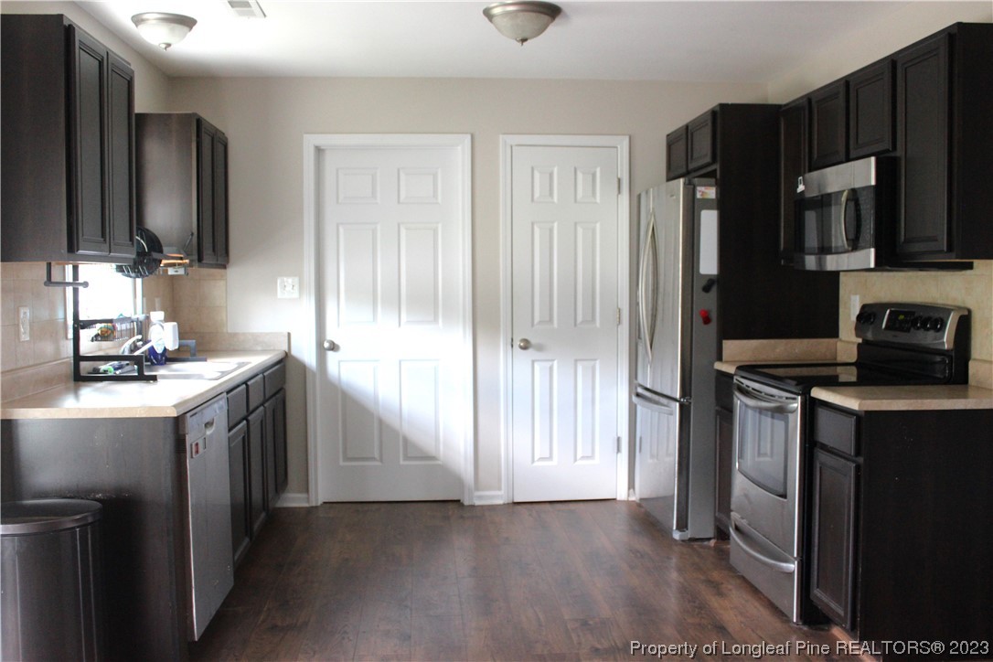 678 Cape Fear Road Raeford, NC 28376 - Photo 8 of 30 a kitchen with stainless steel appliances granite countertop a stove a sink and a refrigerator