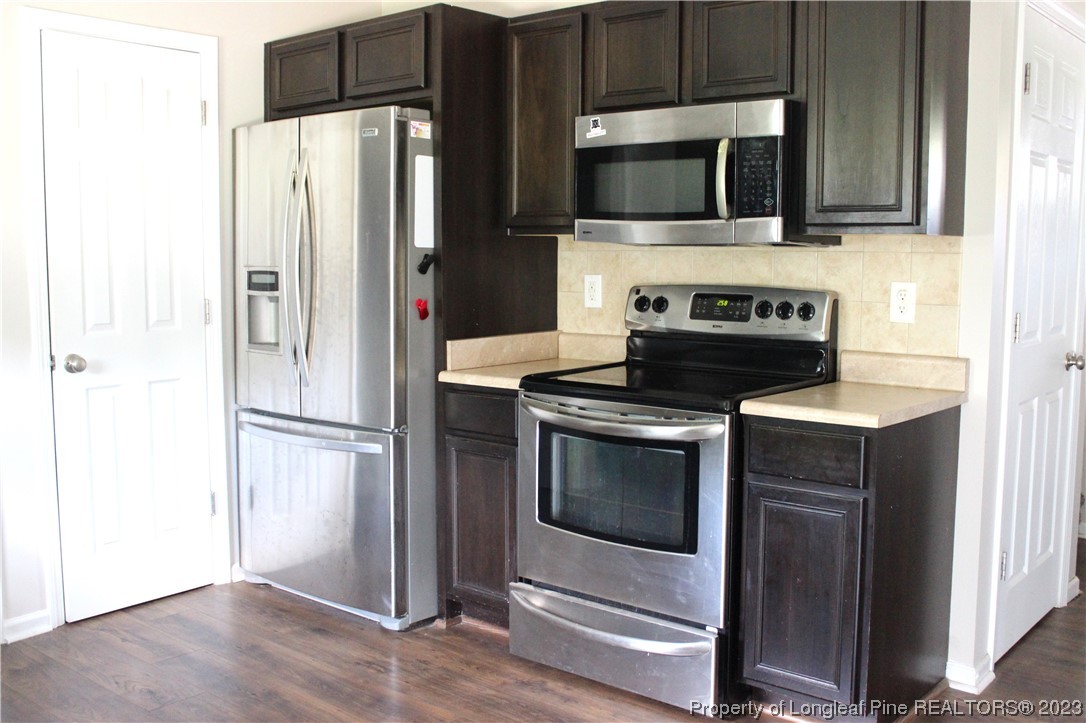678 Cape Fear Road Raeford, NC 28376 - Photo 9 of 30 a kitchen with a refrigerator stove and microwave