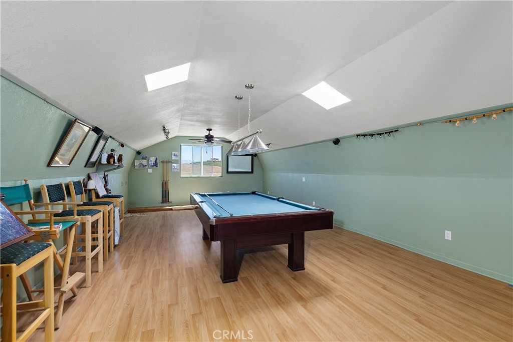 34881 Los Nogales Road Temecula, CA 92592 - Photo 19 of 50 Fully finished loft above barn/workshop with laminate flooring, 2 skylights, a sliding door to the trex deck entry from outside. The pool table, equiptment and chairs are included. ADU potential. Buyers to do thier own investigation regarding this with Riverside County.