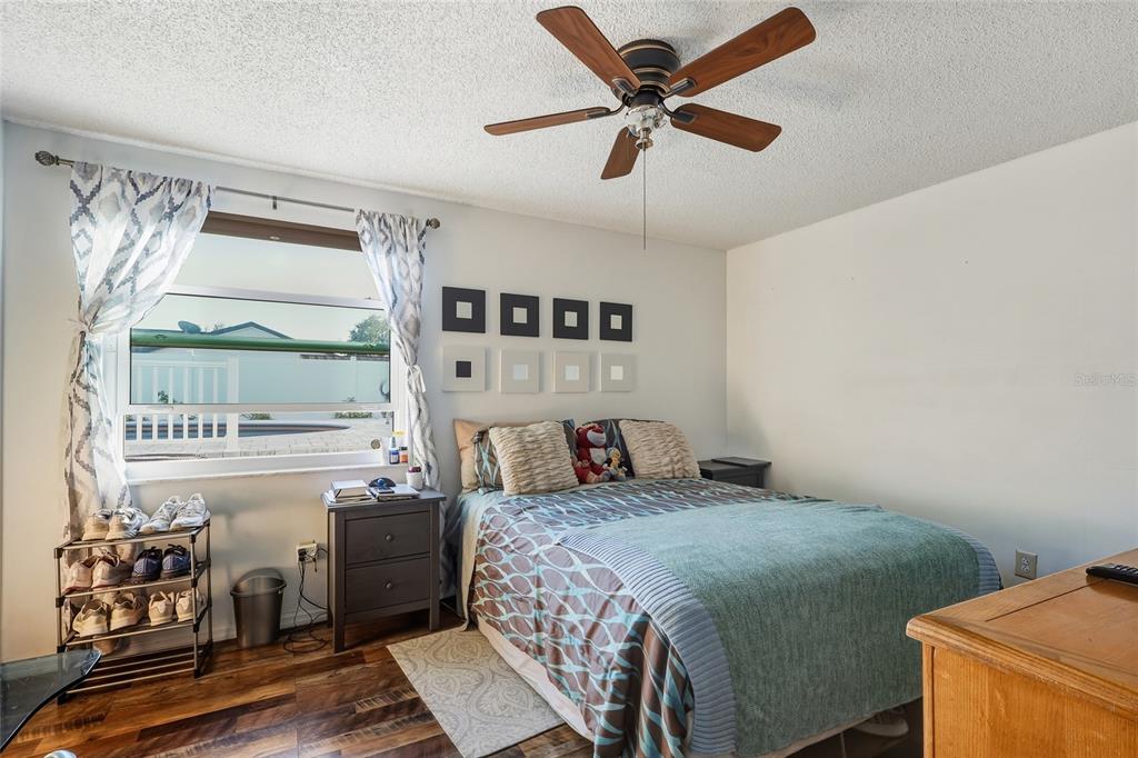 9084 Arndale Circle Tampa, FL 33615 - Photo 11 of 22 a bedroom with a bed and wooden floor