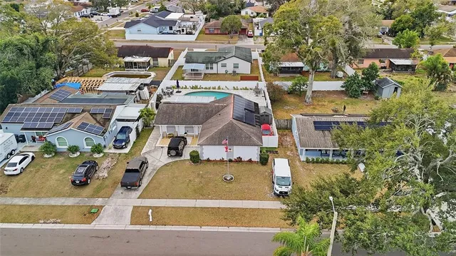 an aerial view of residential houses with outdoor space and swimming pool