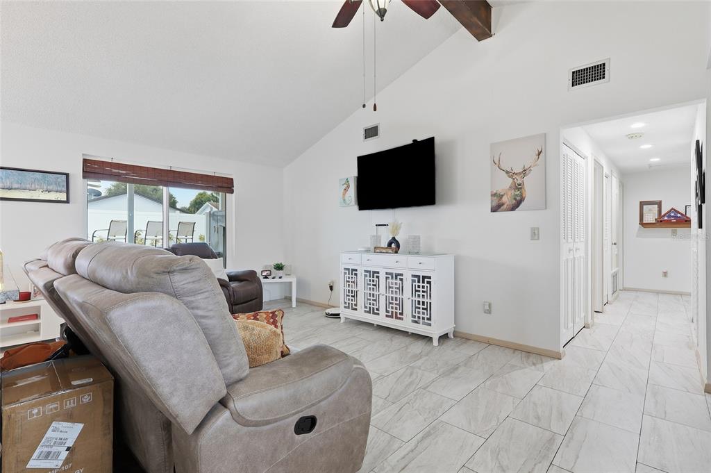 9084 Arndale Circle Tampa, FL 33615 - Photo 3 of 22 a living room with furniture and a flat screen tv