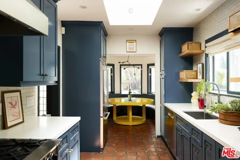 a kitchen with stainless steel appliances a stove and a refrigerator