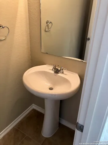 a bathroom with a sink and mirror