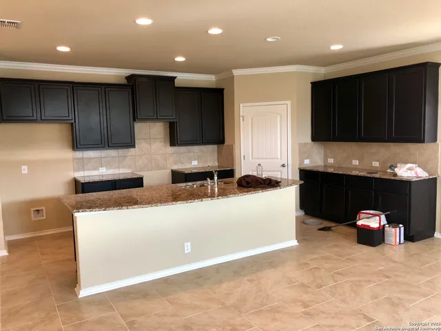 a kitchen with a cabinets and a refrigerator