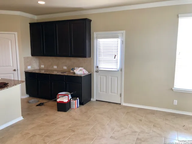 a view of a kitchen with a sink and cabinets