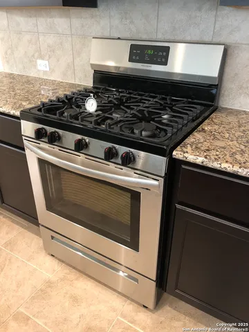 a stove top oven sitting inside of a kitchen