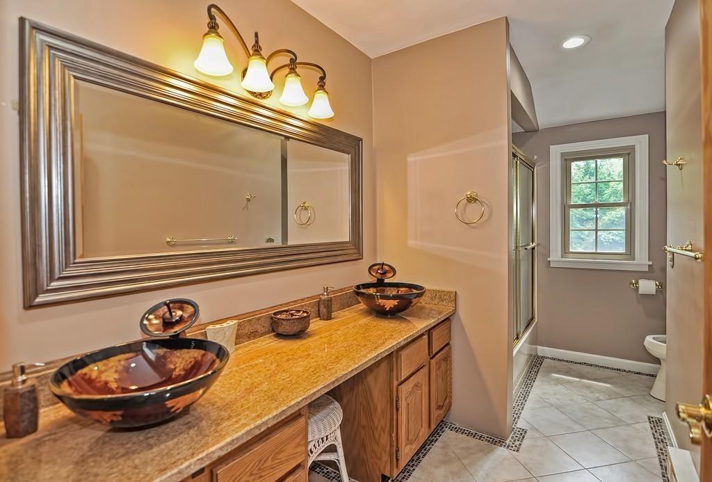 38 Johnson Road Sutton, MA 01590 - Photo 28 of 42 a bathroom with a sink and a mirror