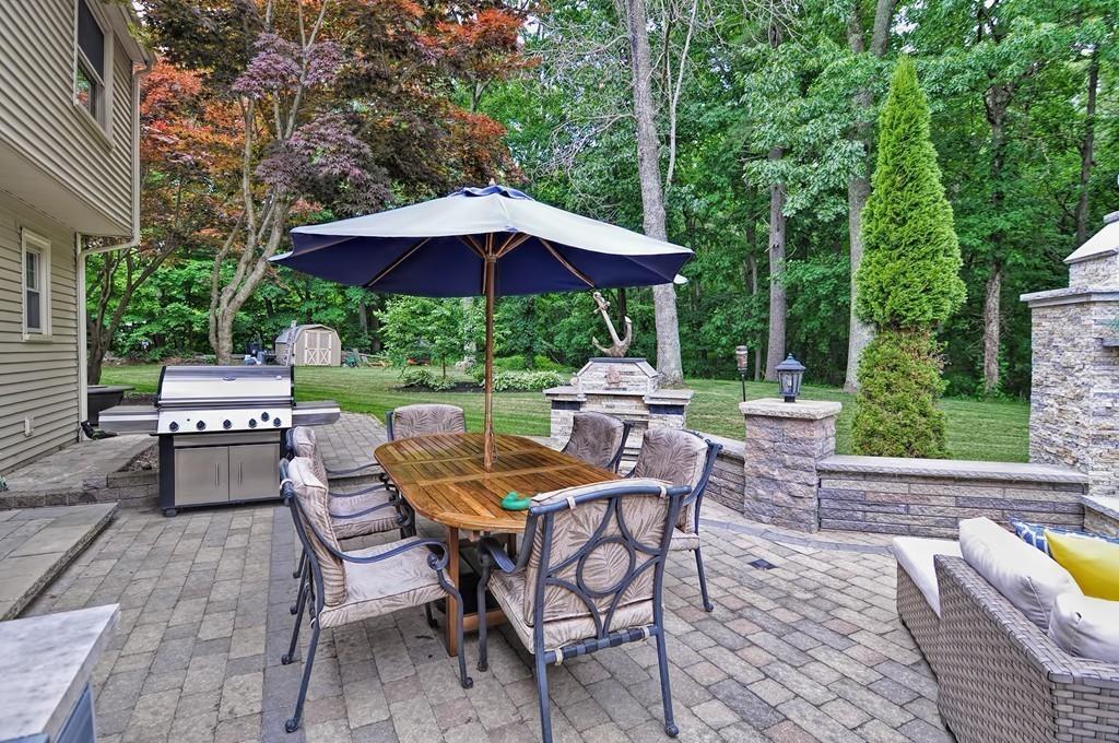 38 Johnson Road Sutton, MA 01590 - Photo 31 of 42 a view of patio with chairs and table under an umbrella